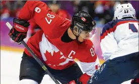  ?? AL BELLO / GETTY IMAGES ?? Canada’s Sidney Crosby gets ready for a faceoff during a game against the United States during the Sochi Winter Olympics on Feb. 21, 2014. The NHL’s CBA extension approved Friday includes an agreement to send players to the Olympics in 2022 and 2026.