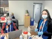  ?? Northeast Colorado Health Department/ Courtesy photo ?? Volunteers shown helping with the on-site COVID-19 vaccinatio­n clinic held March 5 and 6 at Cargill Protein in Fort Morgan include Michelle Pemberton and Mariana Chavez.