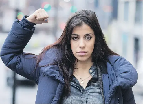  ?? GRAHAM HUGHES FOR NATIONAL POST ?? Activist Neda Topaloski arrives at court in Montreal on Wednesday. Topaloski is charged with disturbing the peace and mischief after protesting topless.