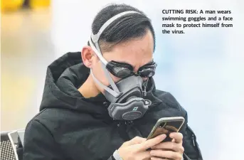  ??  ?? CUTTING RISK: A man wears swimming goggles and a face mask to protect himself from the virus.