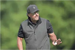  ?? ALASTAIR GRANT/AP ?? Phil Mickelson tied for 33rd in the 48-man field and won $150,000 in the inaugural LIV Golf Invitation­al on Saturday at Centurion Club.