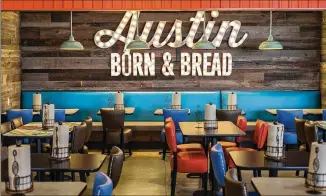  ?? RICARDO B. BRAZZIELL / AMERICAN-STATESMAN ?? Schlotzsky’s rolled out an Austin Eatery in Bee Cave, a new concept that features an open kitchen, funky design elements, recycled wood and corrugated metal.