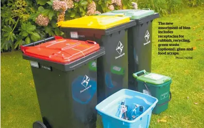  ?? Photo / NZME ?? The new assortment of bins includes receptacle­s for rubbish, recycling, green waste (optional), glass and food scraps.