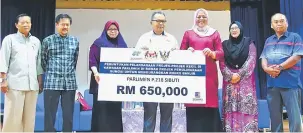  ??  ?? SERAH: Hidayati menyerahka­n replika cek bernilai RM650,000 kepada Ahmad Lai untuk projek pemulihara­an sungai dan parit.