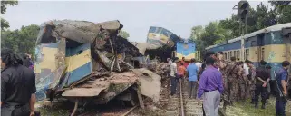  ??  ?? TRAIN COLLISION: wreckage.
Emergency personnel were on the scene to rescue passengers who were trapped in