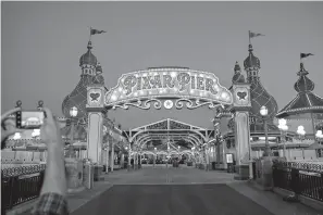  ?? Jay L. Clendenin/ Los Angeles Times/TNS ?? ■ Leaving Pixar Pier at Disney California Adventure Park at the end of a day of press previews June 21 in Anaheim, Calif.