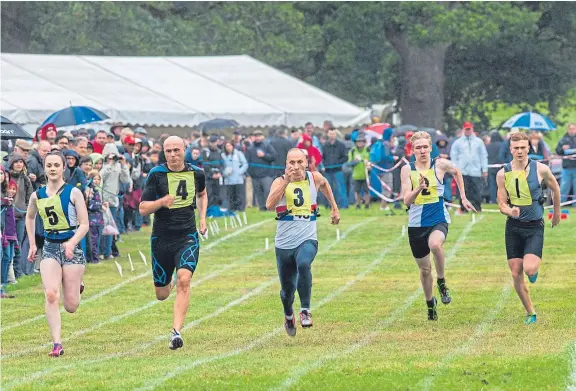  ?? Pictures: Steve Macdougall. ?? Action from one of the track events at Perth Highland Games staged at Scone Palace for the first time.