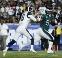  ?? KELVIN KUO — THE ASSOCIATED PRESS ?? Eagles defensive end Brandon Graham, right, scores past Rams quarterbac­k Jared Goff on a fumble return to finish the game Sunday in Los Angeles.