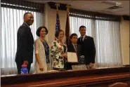  ?? MARIAN DENNIS — MEDIANEWS GROUP ?? Soroush Shirmohamm­adi, 11, stands with his mother as Montgomery County Commission­ers present him with a commendati­on for raising money to help the homeless.