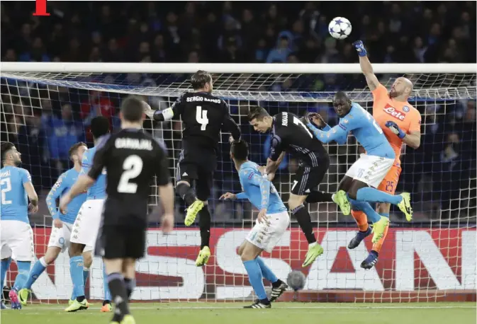  ??  ?? NAPLES: Napoli goalkeeper Pepe Reina, right, punches the ball away during the Champions League round of 16, second leg, soccer match between Napoli and Real Madrid at the San Paolo stadium in Naples, Italy, yesterday. — AP