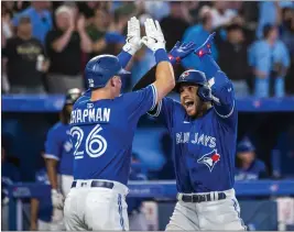  ?? CHRISTOPHE­R KATSAROV — THE CANADIAN PRESS VIA AP ?? The Blue Jays’ George Springer celebrates with Matt Chapman after hitting a grand slam during the sixth inning to turn as 4-3lead into an 8-3advantage against the Cardinals.