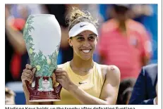  ?? ROB CARR / GETTY IMAGES ?? Madison Keys holds up the trophy after defeating Svetlana Kuznetsova in the women’s final of the Western and Southern Open on Sunday in Mason. Keys rallied late in both sets to win 7-5, 7-6 (5) for her second title of the season.