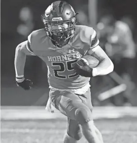  ?? MIKE CARDEW/AKRON BEACON JOURNAL ?? Highland’s Casey Myser runs for a gain against Barberton during the first half of the game at Highland High School Stadium in Granger Township.