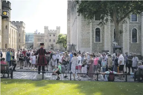  ?? AP ?? A Yeoman Warder leads the first tour of the Tower of London in 16 months after Covid-19 restrictio­ns were lifted in England