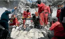  ?? PHOTO: REUTERS ?? Iraqi firefighte­rs look for bodies buried under the rubble, of civilians who were killed after an air strike against Islamic State triggered a massive explosion in Mosul.