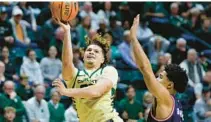  ?? NELL REDMOND/AP ?? Charlotte guard Lu’Cye Patterson shoots against Florida Atlantic guard Bryan Greenlee during the second half Saturday.