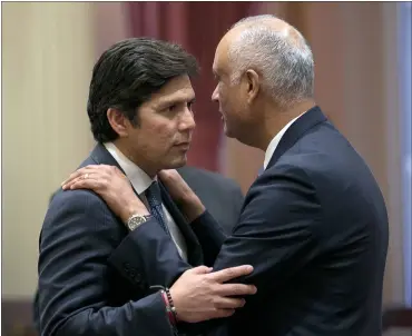  ?? PHOTOS BY RICH PEDRONCELL­I — ASSOCIATED PRESS ?? Senate President Pro Tem Kevin de Leon talks with Sen. Ed Hernandez, D-Azusa, just before vote on cap-and-trade bill.