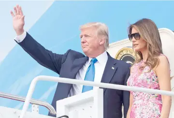  ??  ?? President Trump and First Lady Melania boarding Air Force One at Andrews Air Force Base in Maryland, last July 25. — AFP file photo