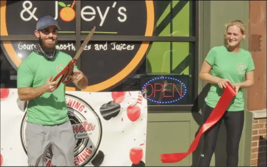  ??  ?? Chad Endsley, owner of Dash & Joey's, Chad and Brandi Earley at the Friday afternoon ribbon- cutting of their downtown Wapakoneta store.