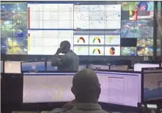  ?? ALAN GOMEZ, USA TODAY ?? Law-enforcemen­t officials monitor video feeds from around the city at Rio’s Integrated Center of Command and Control.