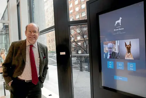  ?? PHOTOS: AP ?? American Kennel Club Museum of the Dog executive director Alan Fausel smiles after finding his dog breed match – a great dane – at an interactiv­e kiosk at the museum’s new home in New York City.