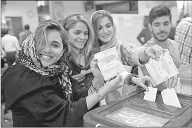  ?? AP/VAHID SALEMI ?? Iranians cast their ballots in the presidenti­al election Friday at a polling station in Tehran.