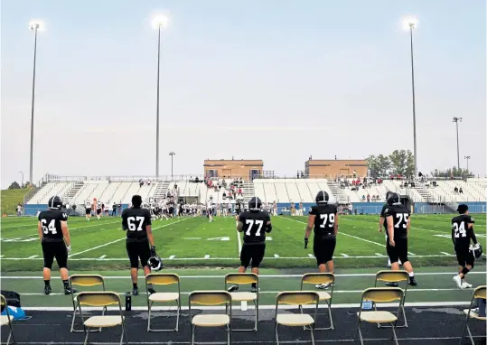  ?? Andy Cross, The Denver Post ?? The Pomona Panthers socially distance on the sideline during their game against Chaparral at the North Area Athletic Complex on Thursday night. After moving high school football to spring, CHSAA reversed course and allowed a fall season.