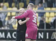  ?? ?? David Martindale, left, and Gary Maley embrace at full-time