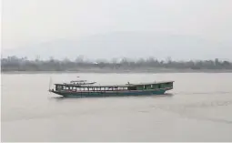  ?? Reuters file photo ?? A long boat sails near the port of Chiang Saen on the Thai side of the Golden Triangle at the border between Thailand, Laos and Myanmar in the Mekong river.—