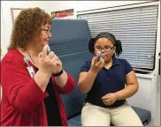  ?? CONTRIBUTE­D ?? DPS school nurse Lisa Montgomery works with a student through the mobile health unit.