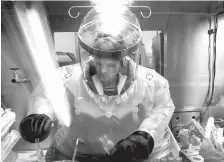  ?? Associated Press ?? Microbiolo­gist Ruth Bryan works with BG nerve agent simulant in a Class III Glove Box May 11, 2003, in the Life Sciences Test Facility at Dugway Proving Ground, Utah.