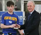  ??  ?? Rory McHugh receives man of the match award from John Murphy.