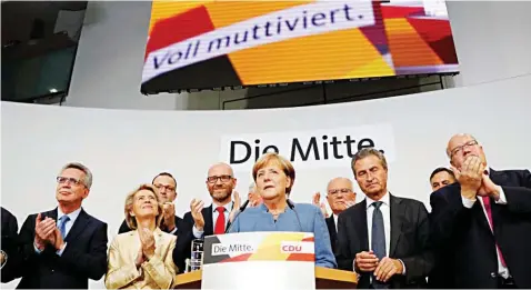  ?? PHOTO: REUTERS ?? Christian Democratic Union (CDU) party leader and German Chancellor Angela Merkel (centre) reacts on first exit polls in the German general election (Bundestags­wahl) in Berlin, Germany.