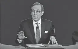  ?? AP ?? Chris Wallace of Fox News moderates the debate of President Donald Trump and former Vice President Joe Biden in Cleveland on Sept. 29, 2020.
