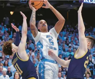  ?? CHRIS SEWARD/AP ?? North Carolina forward Armando Bacot, a Richmond native, goes up for a shot between Notre Dame guard Braeden Shrewsberr­y, left, and forward Matt Zona on Tuesday night.