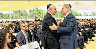  ?? KOBI GIDEON / ISRAEL GOVERNMENT PRESS OFFICE ?? Israeli Prime Minister Benjamin Netanyahu (right) greets Chemi Peres, Shimon Peres’ son, at the funeral at Mount Herzl Cemetery on Friday in Jerusalem. Delegation­s from 75 countries attended.