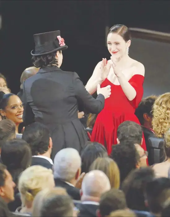  ?? Brian van der Brug Los Angeles Times ?? AMY SHERMAN-PALLADINO, in hat, wins a writing award as her “Marvelous Mrs. Maisel” star and actress winner Rachel Brosnahan applauds.