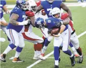  ?? BILLKOSTRO­UN/AP ?? The Cardinals’ Haason Reddick, right, knocks the ball loose as he tackles Giants quarterbac­k Daniel Jones during the first half Sunday in East Rutherford, N.J.