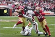  ?? SUE OGROCKI — THE ASSOCIATED PRESS, FILE ?? Niners running back Christian McCaffrey, left, runs against Browns cornerback Martin Emerson Jr., middle, and safety Juan Thornhill, bottom, during the first half on Oct. 15.