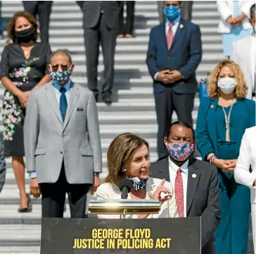  ?? AP ?? House Speaker Nancy Pelosi, of California, joined by House Democrats spaced for social distancing, speaks during a news conference on the House East Front Steps on Capitol Hill in Washington yesterday ahead of the House vote on the George Floyd Justice in Policing Act of 2020.