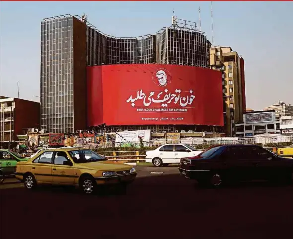  ?? REUTERS PIC ?? A billboard in Teheran featuring a picture of Iranian Quds Force head Qasem Soleimani, who was killed in a United States drone strike.