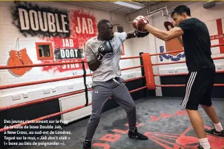  ??  ?? Des jeunes s’entraînent sur le ring de la salle de boxe Double Jab, à New Cross, au sud-est de Londres. Tagué sur le mur, « Jab don’t stab » (« boxe au lieu de poignarder »).