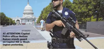  ?? AP PHOTO ?? AT ATTENTION: Capitol Police officer Nathan Rainey stands guard on Capitol Hill in Washington yesterday.