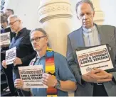  ?? JAY JANNER, AUSTIN AMERICAN- STATESMAN, VIA AP ?? Members of the clergy pray outside the House chamber in Austin in opposition to bills they consider anti- LGBT.