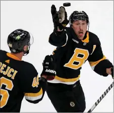  ?? MATT STONE — BOSTON HERALD ?? David Krejci, left, watches as Bruins teammate Brad Marchand grabs a flying puck during the second period of a Feb. 20 game against the Ottawa Senators at the TD Garden.