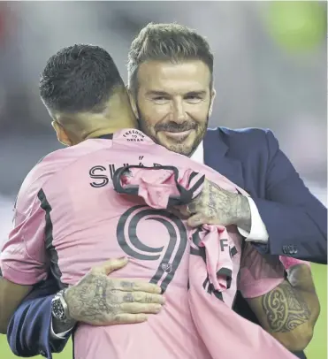  ?? ?? David Beckham embraces Luis Suarez ahead of the striker’s MLS debut against Real Salt Lake