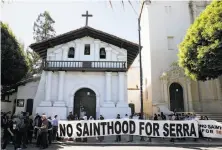  ?? Lea Suzuki / The Chronicle ?? In San Francisco, demonstrat­ors protest the Junipero Serra canonizati­on in front of Mission Dolores.