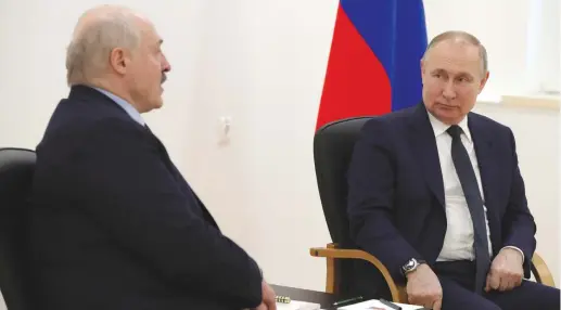  ?? (Sputnik/Kremlin/Reuters) ?? RUSSIAN PRESIDENT Vladimir Putin listens to Belarusian President Alexander Lukashenko during a meeting in Russia last month. Lukashenko has said Armenia can’t avoid Russia bringing it into an axis with Belarus.