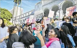  ?? Stuart Palley For The Times ?? PROTESTERS dance and chant slogans on the steps of Los Angeles City Hall. No arrests or major injuries were reported during the march, officials said.
