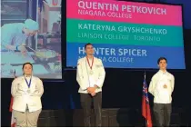  ??  ?? Quentin Petkovich and Hunter Spicer stand proudly as culinary arts gold and bronze medalists, respective­ly, at the Skills Ontario Competitio­n. In June, Petkovich went on to win silver at Skills Canada.